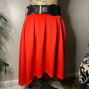Red high low skirt with belt.